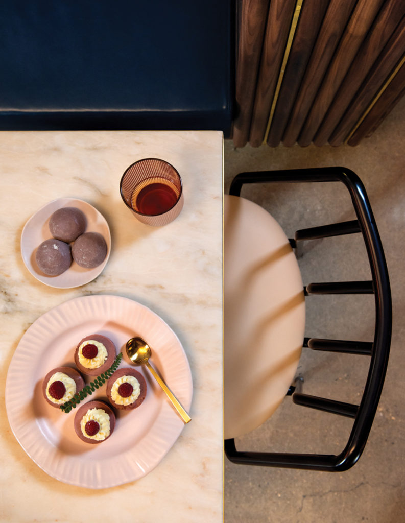 Table and chairs with sweets.