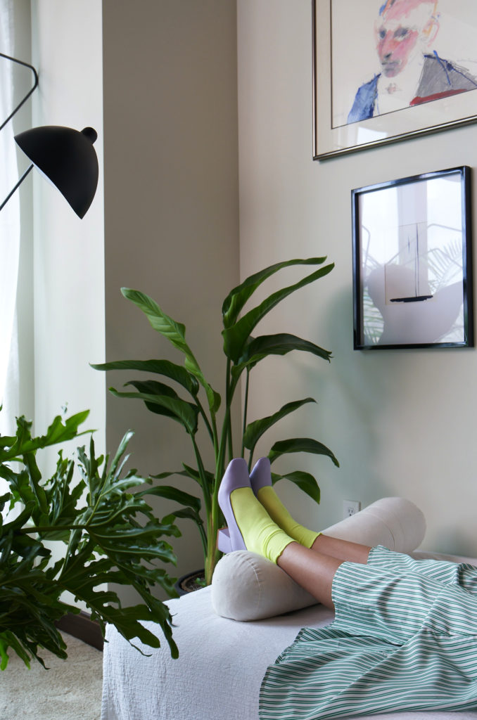 Woman laying on couch with plants