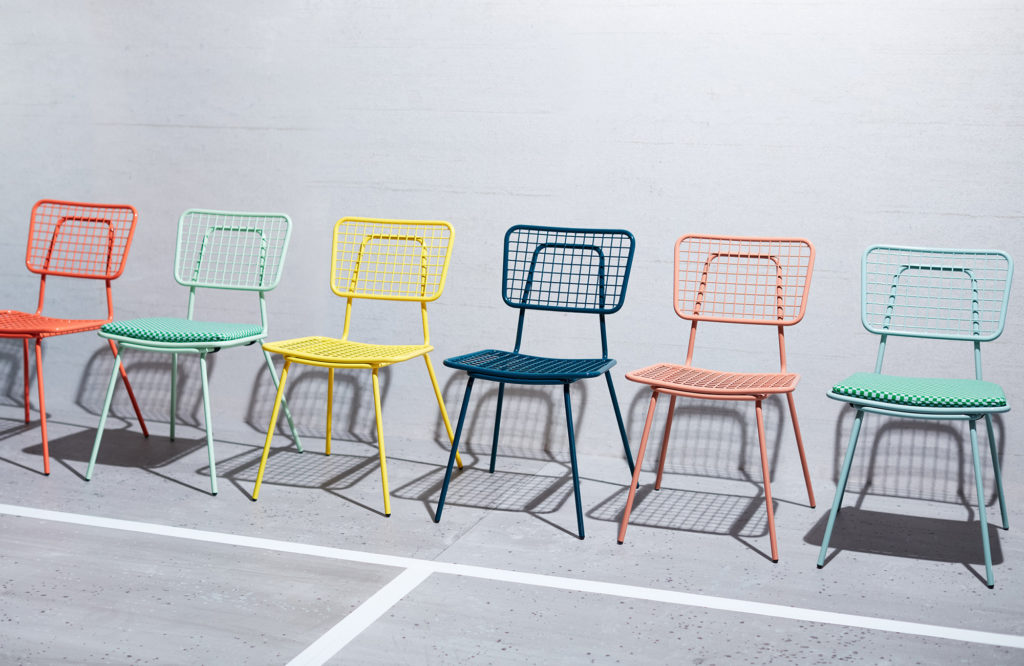 A row of metal wire chairs in different colors