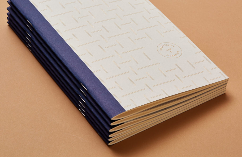 stack of Helbraun Levey notebooks