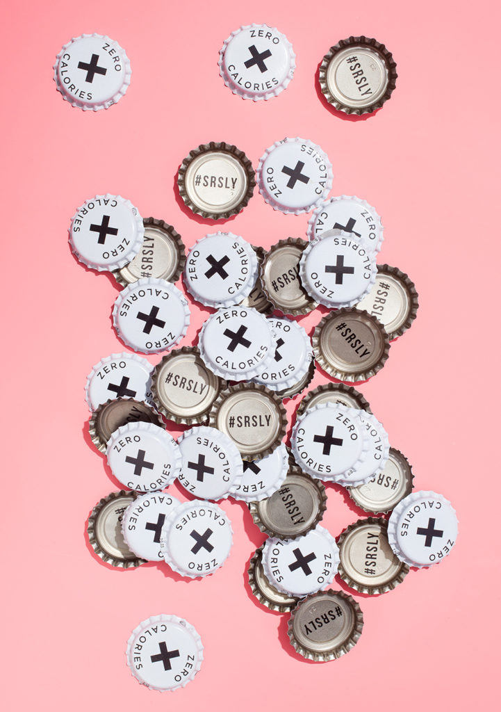 pile of Seriously Unsweetened bottle caps